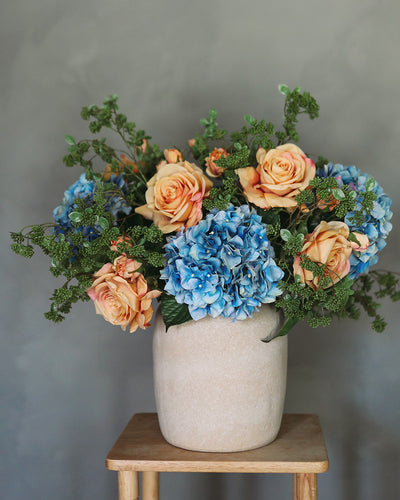 Faux Flower Arrangement with Orange Roses and Blue Hydrangeas