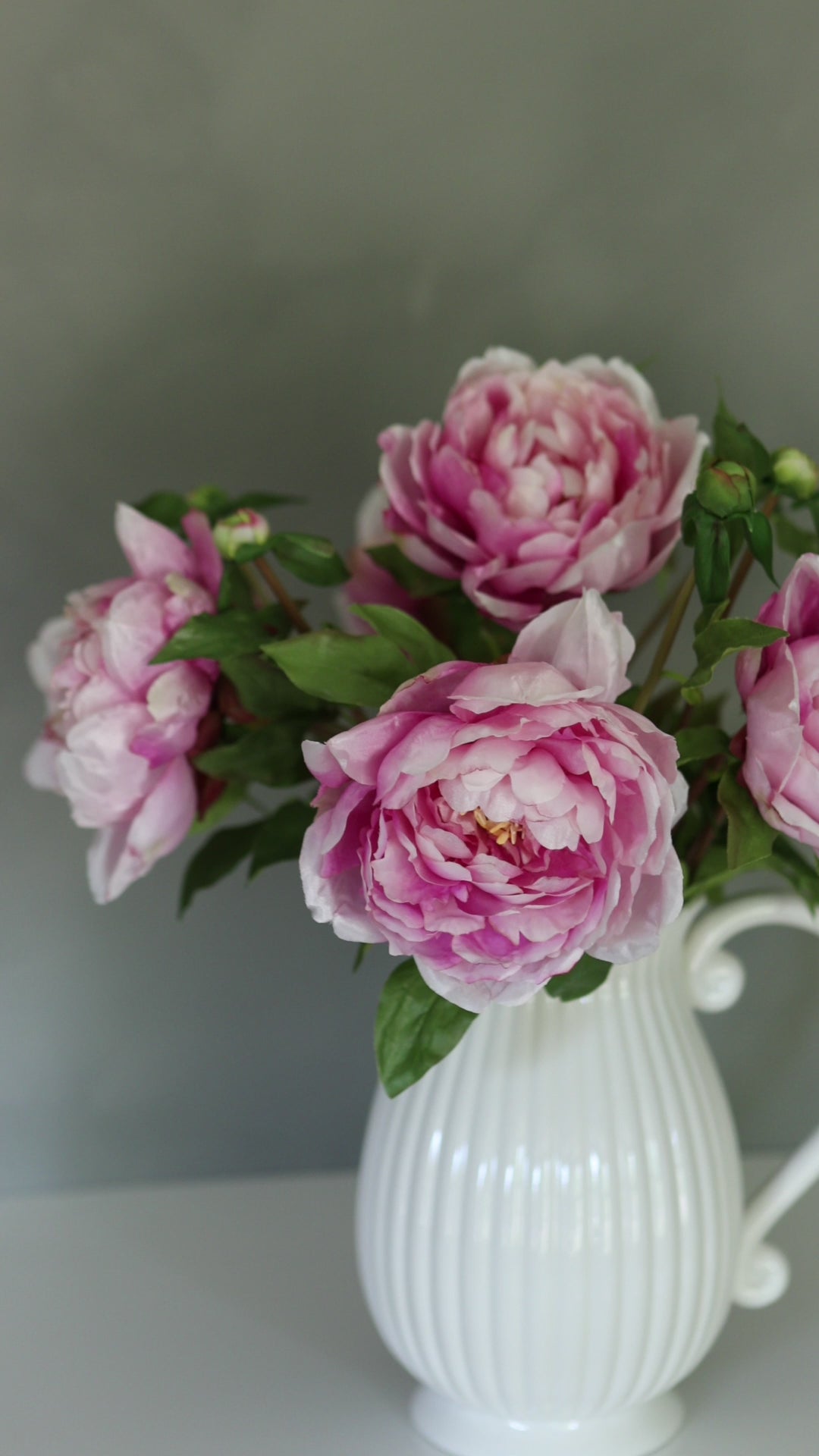 Video Showcasing Pink Peonies in White Pitcher Vase